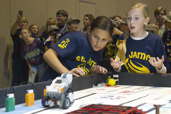 Two students anxiously watch their robot during the 2012 FIRST LEGO League Mississippi Championship Tournament in Hattiesburg, Miss., on Dec. 1. (Credit: NASA/SSC)
