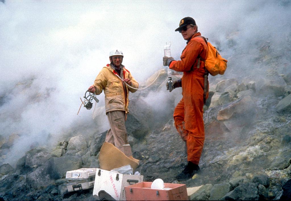 Two volcanologists working on Mt. St. Helens in protective gear