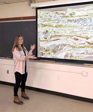 Student presenting at a screen