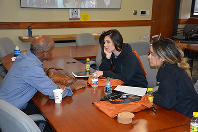 Two students meeting with a teacher