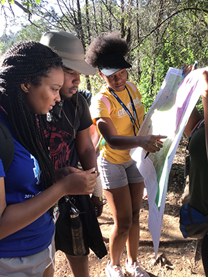 students looking at a map in the field