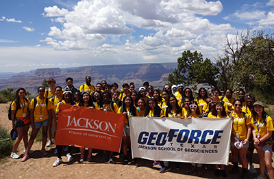 Group photo of GeoForce students holding banners