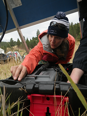 student examining equipment in a box