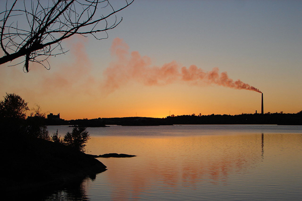 Sunset skyline of Sudbury, Ontario, Canada, with the Inco Superstack seen across Ramsey Lake. Licensed under Creative Commons, CC-BY-SA-3.0, https://creativecommons.org/licenses/by-sa/3.0/deed.en Image Credit: Wikimedia Commons User P199