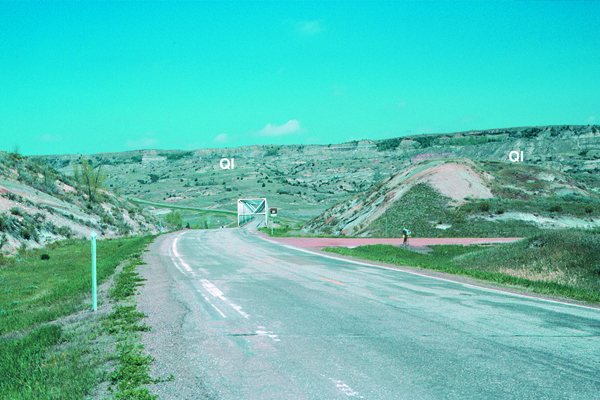 Fig. 3. U.S. Highway 85 crossing the Little Missouri River. Seventy-five percent of the rocks in this photograph, all of those in the foreground and the rocks along the north valley wall in the background have slid and are out of place. Credit: E. Murphy 