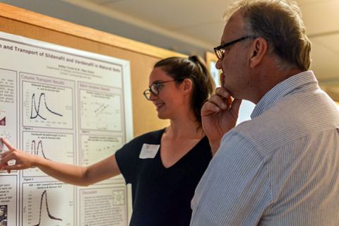 Student presenting a scientific poster and explaining research. Image Credit: Jennifer Perez, AGI Life in the Field 2017