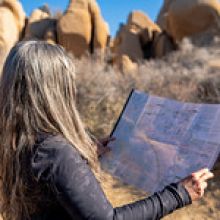 A woman uses a map to navigate Joshua Tree National Park.