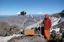 A U.S. Geological Survey seismologist installs a monitoring station on Mt. Rainier. Image Credit: U.S. Geological Survey