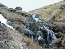 Snow melt. A small waterfall in the Glenach Burn. 