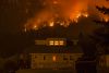 Wildfire burns on a mountain behind a house, First Creek Fire, Washington. Image Credit: U.S. Forest Service