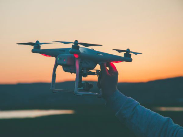 A hand holding a drone ready for launch