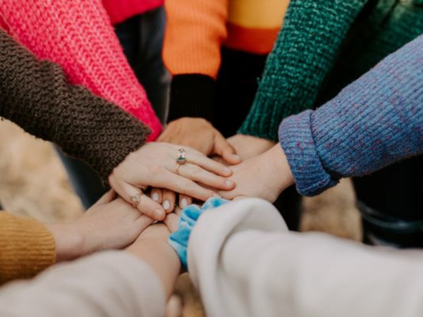 A group of hands together in a circle