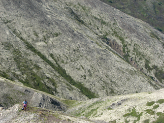 Chugach and Talkeetna Mountains in Alaska. Woman onmountainside.