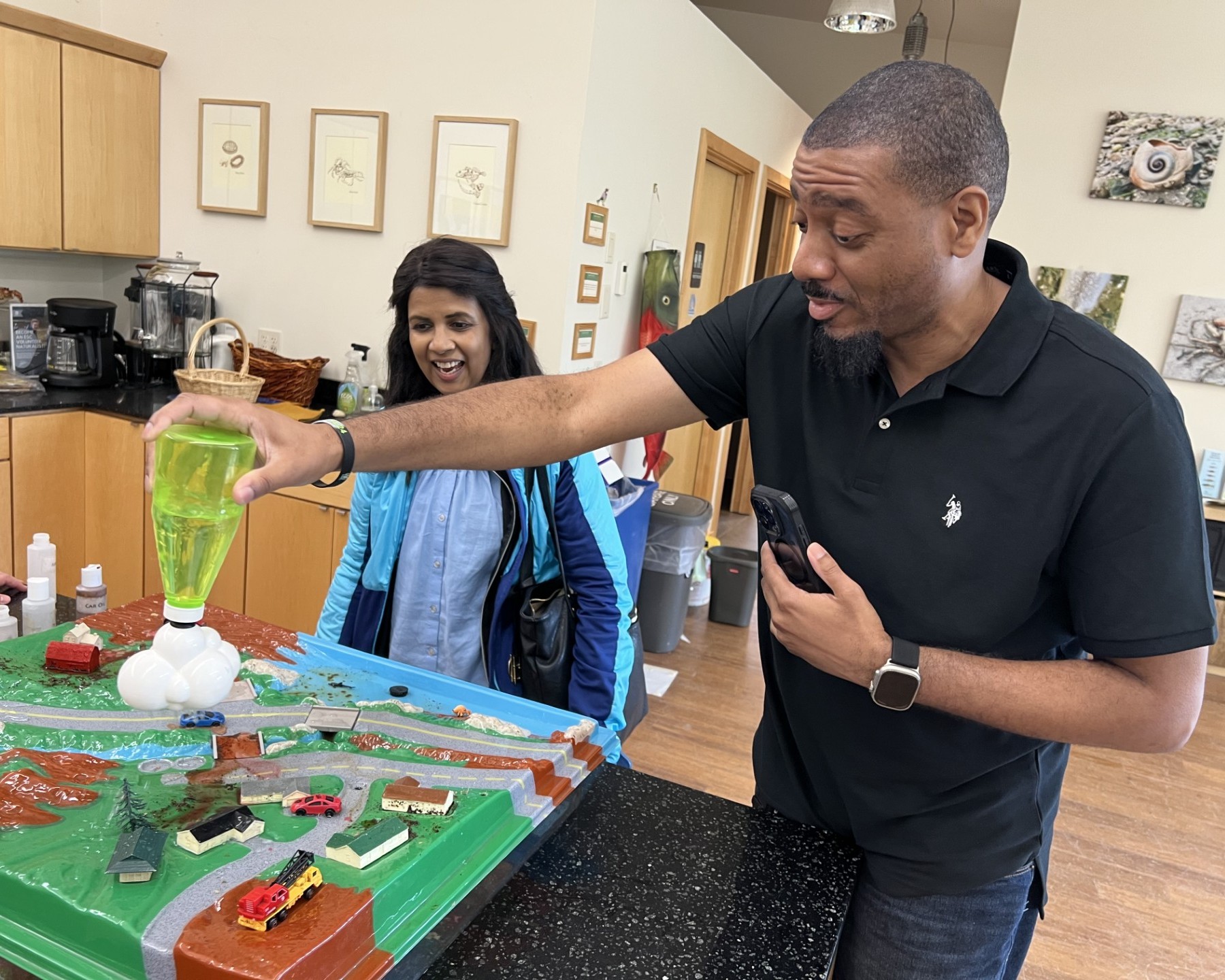 Teachers interact with a stomwater model.