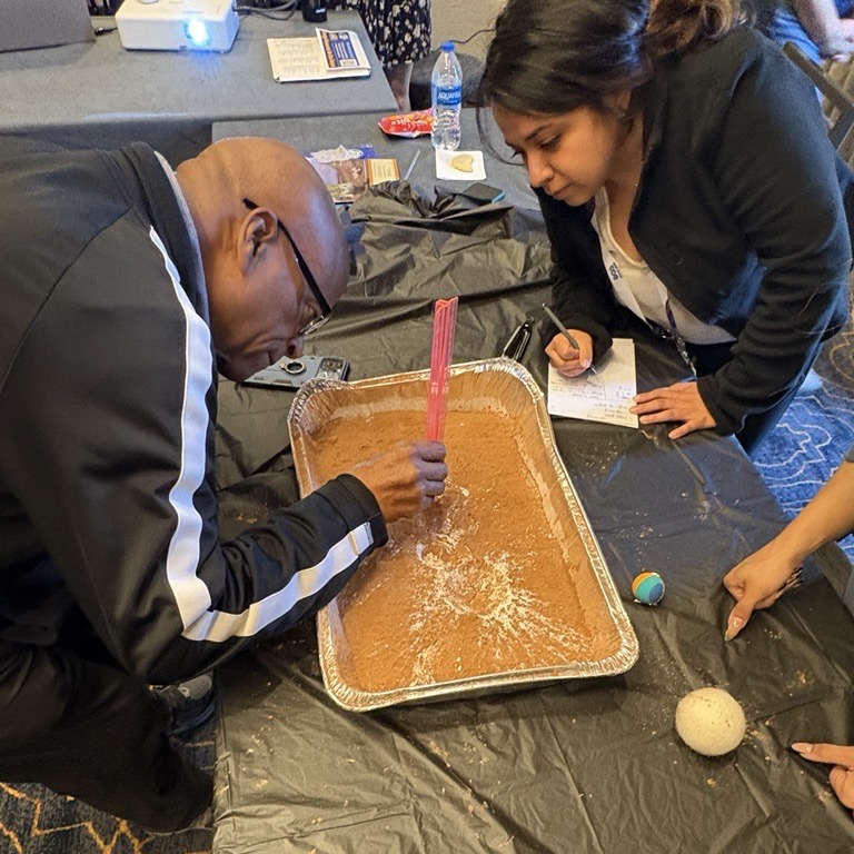 Teachers completing a cratering activity.
