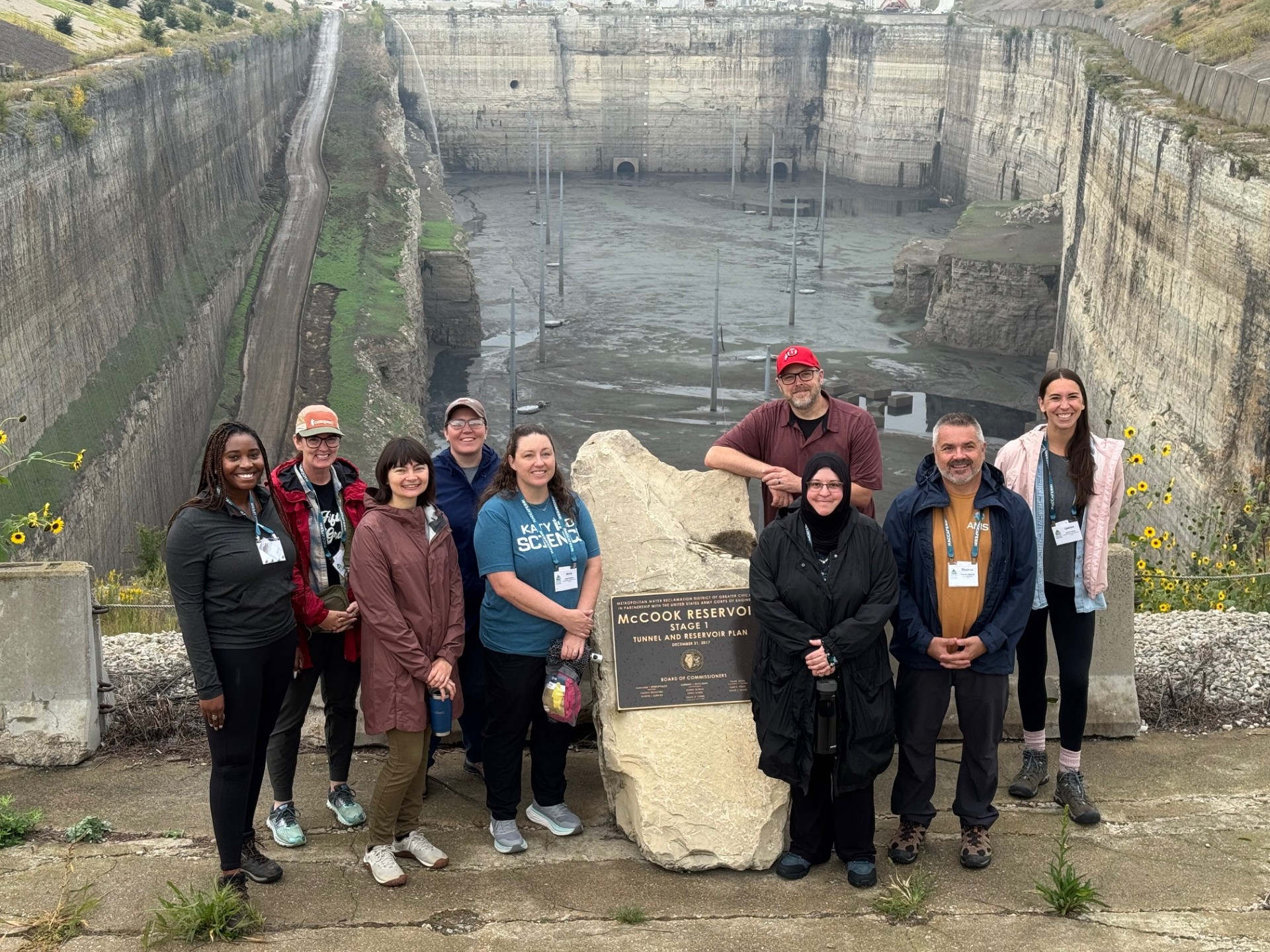 AEG Teacher Photo Group picture of teachers at a field stop in front of a quary used for stormwater runoff and untreated sewage.