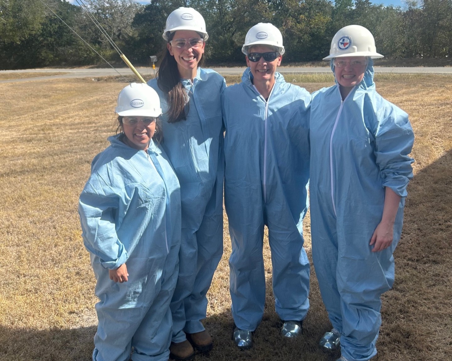 Teachers and workshop leaders dressed in fire protection suits and other safety gear.