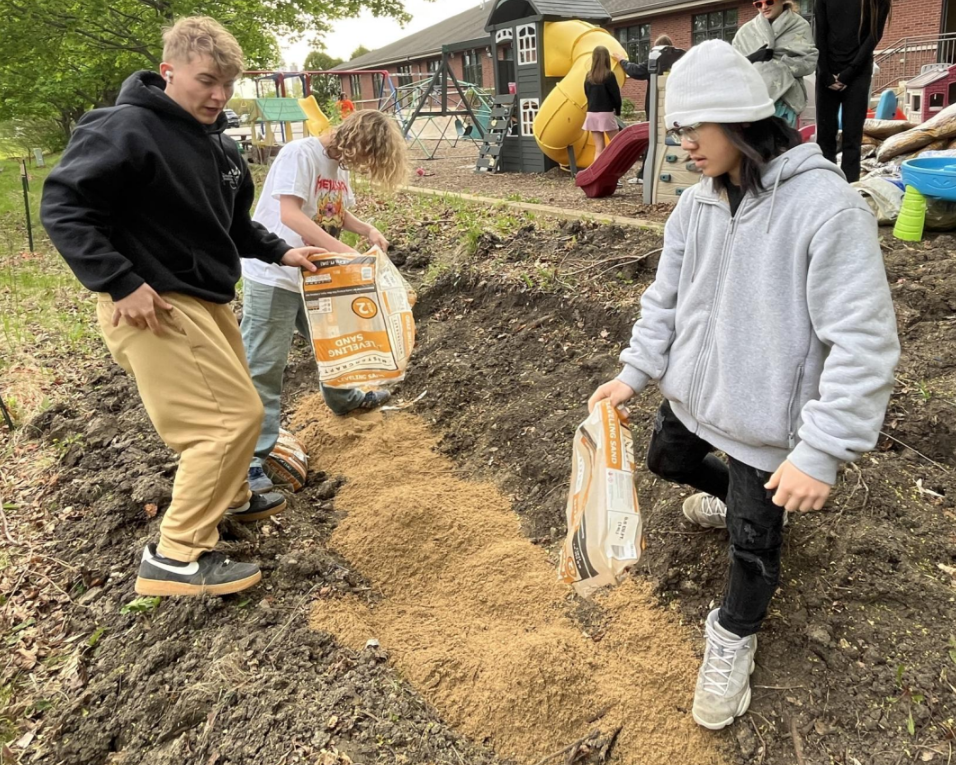 students installing a rain garden at a private school