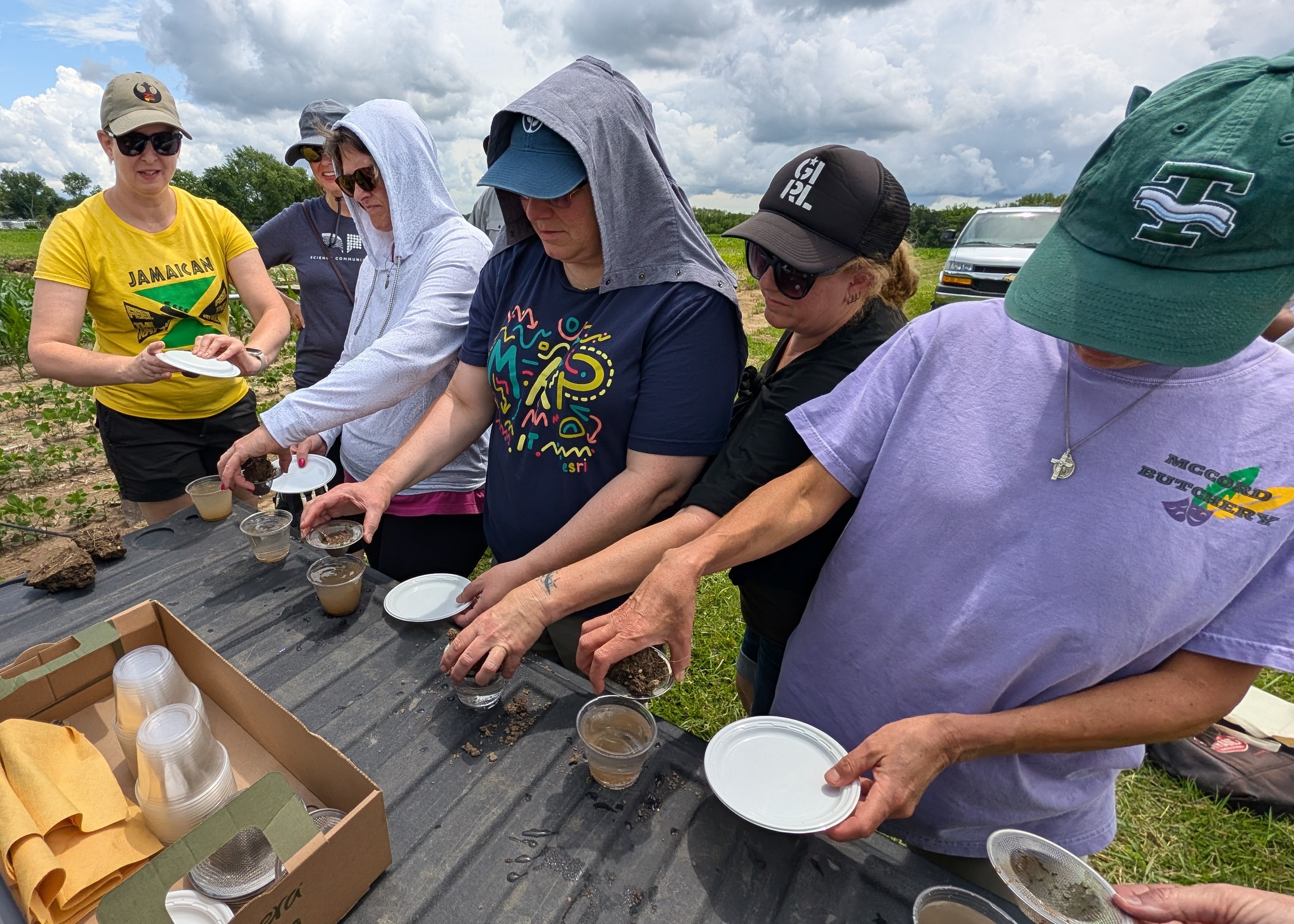 SSW participants doing a soil aggregate test by placing soil into water