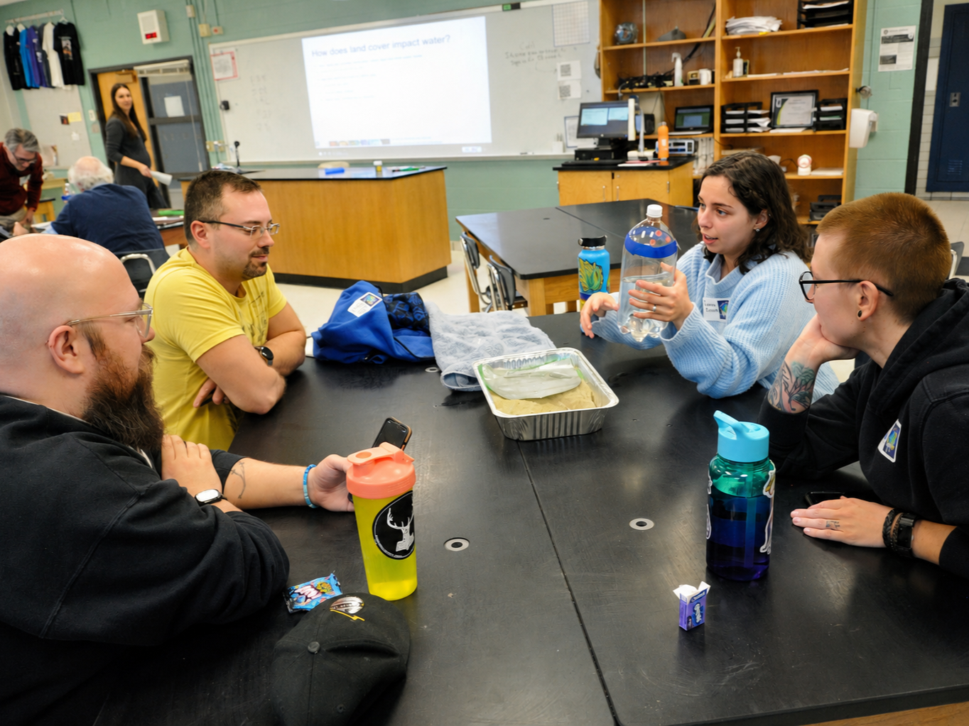 Teachers investigating surface runoff with hands-on activity