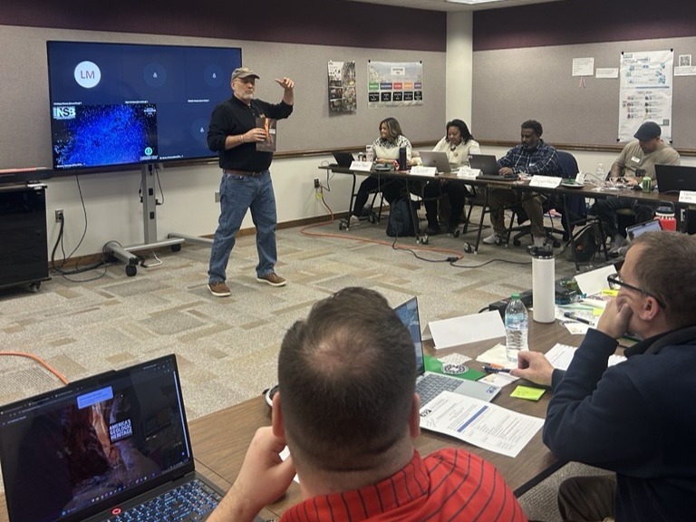 AGI presenting in front of educators in a classroom