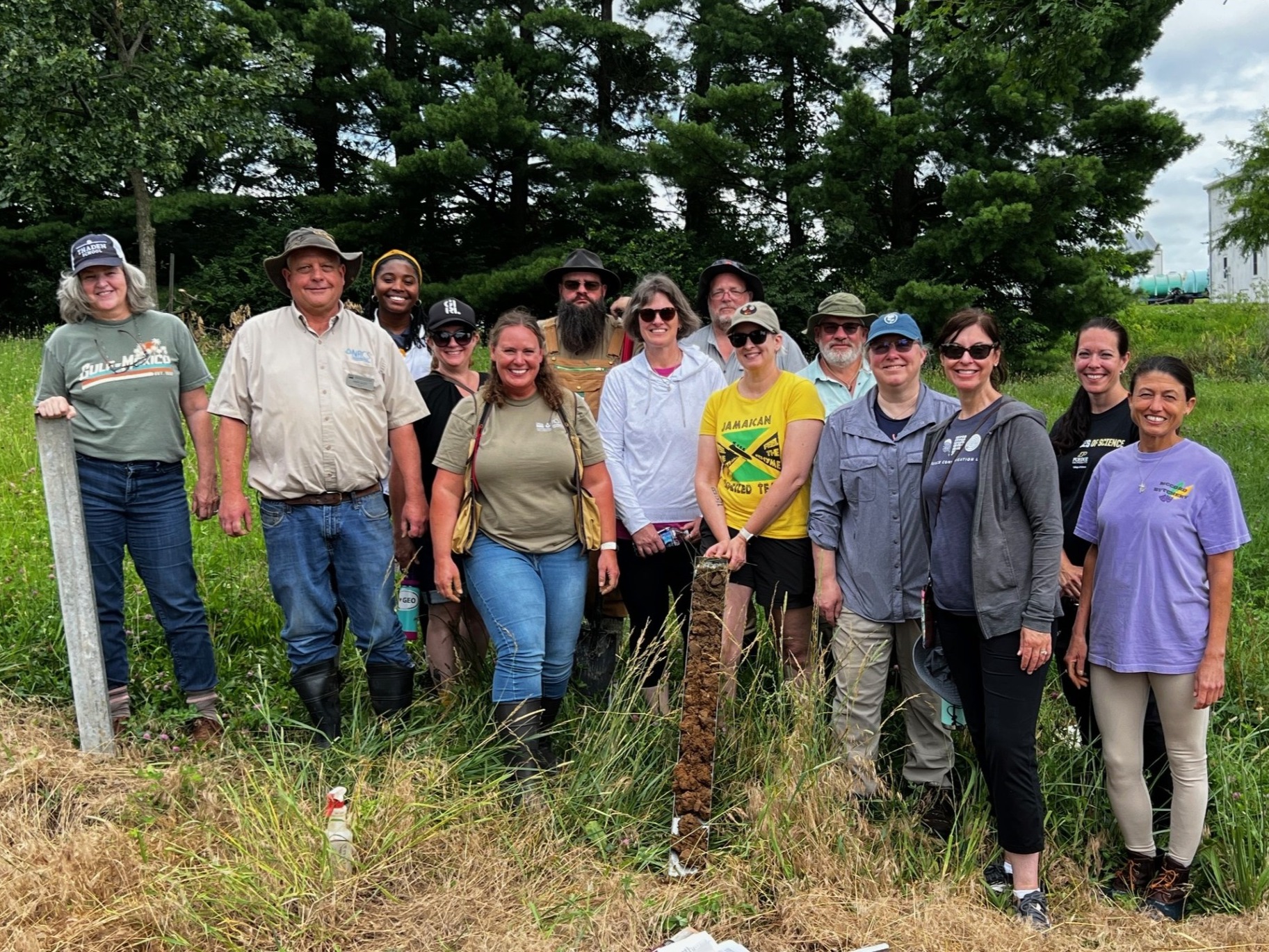 teachers and facilitators standing in group smiling at Purdue University's Farm