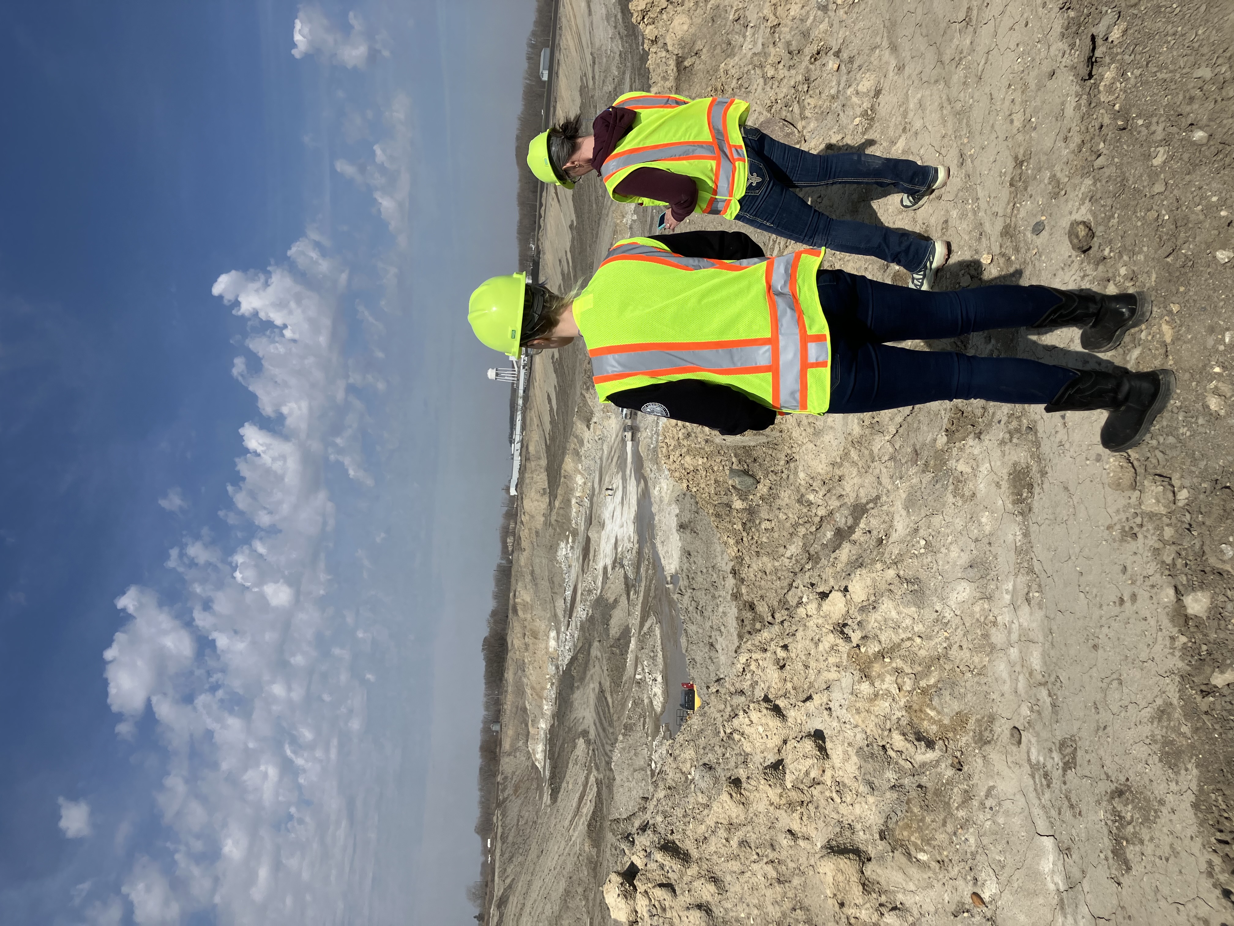 Overlooking an open pit mine two people overlooking an open pit mine
