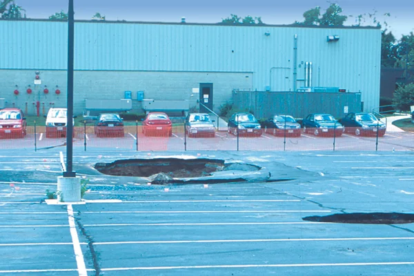 Figure 1: Sinkholes in collapsed parking area, Frederick, Maryland. Sinkholes form in carbonate areas as the dissolving and weakening of bedrock cause it to collapse. Credit: D.K. Brezinksi