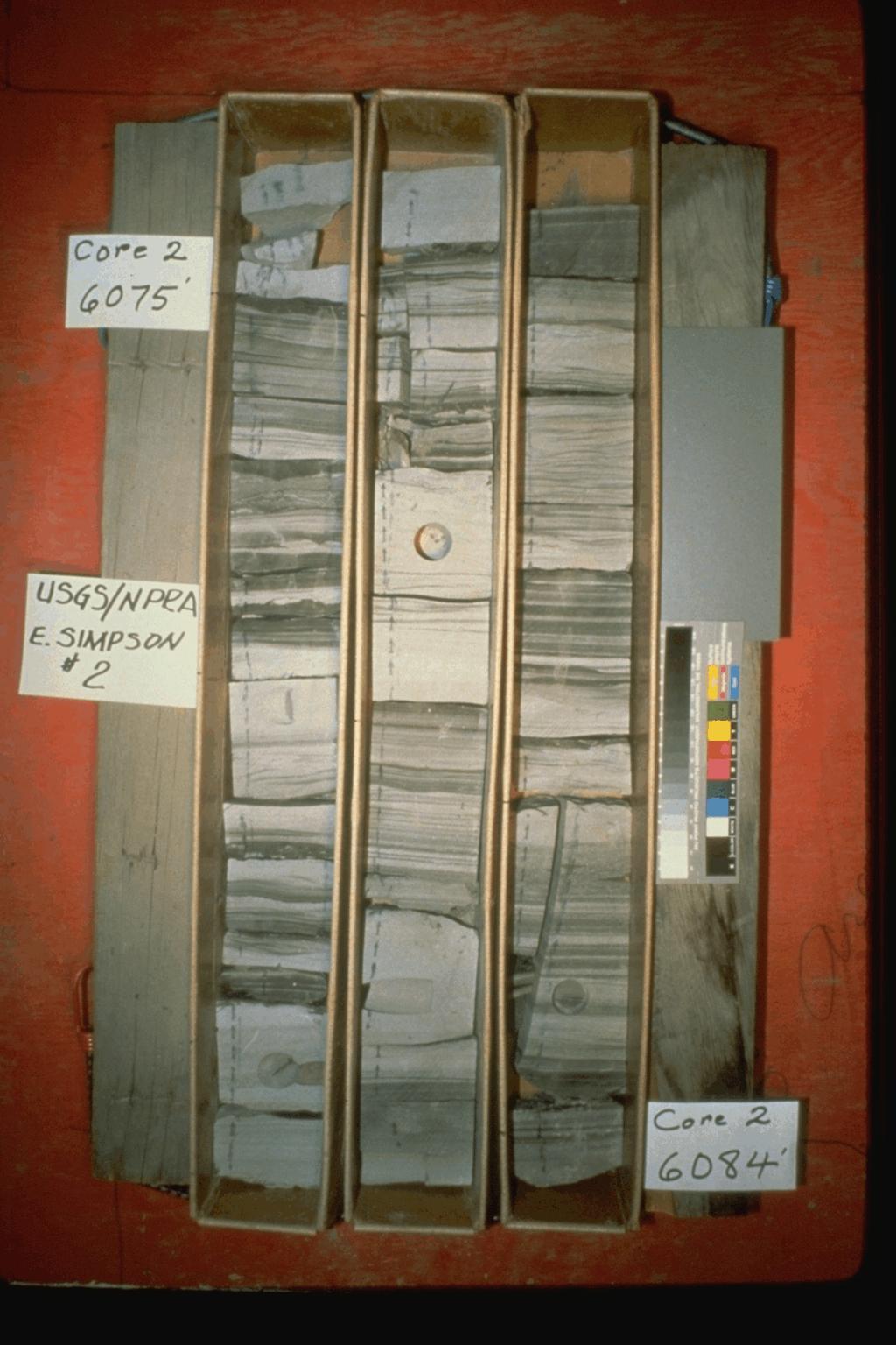 A box containing 9 feet of 4-inch diameter core from the National Petroleum Reserve, Alaska, showing the fine-scale structure and composition of the rock layers being drilled.