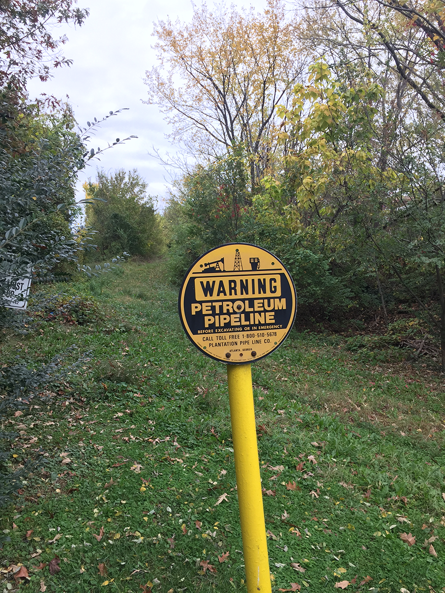 Sign indicating a buried refined-product pipeline in Alexandria, Virginia. Image credit: Ben Mandler, American Geosciences Institute. Sign indicating a buried refined-product pipeline in Alexandria, Virginia.