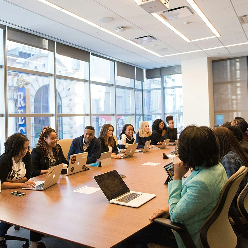 Faculty meeting around a table.